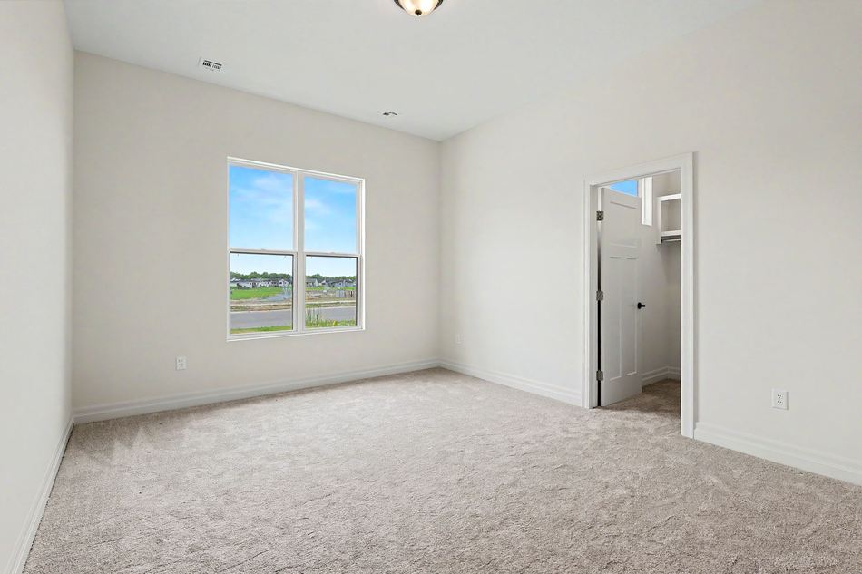 Primary bedroom with corner windows at 14007 E Wassall St. — Wichita, KS
