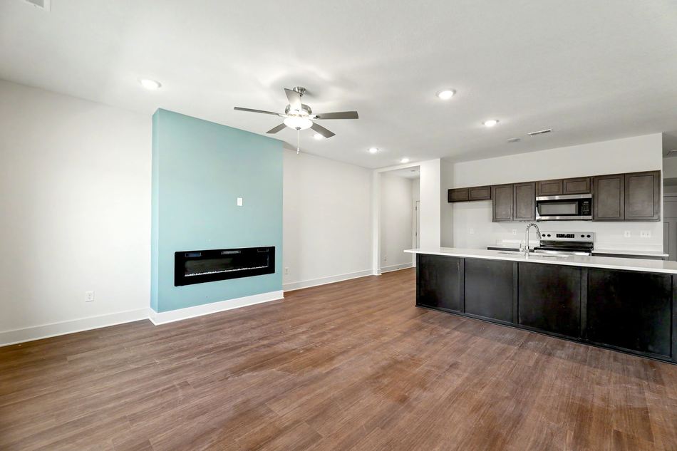 Great room with linear fireplace open to the kitchen at 2927 S Cedar Crest St. — Wichita, KS