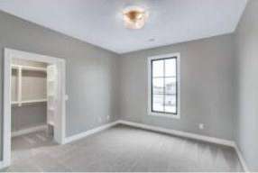 Completed RJ Castle Homes secondary bedroom with walk-in closet entry – Wichita, KS