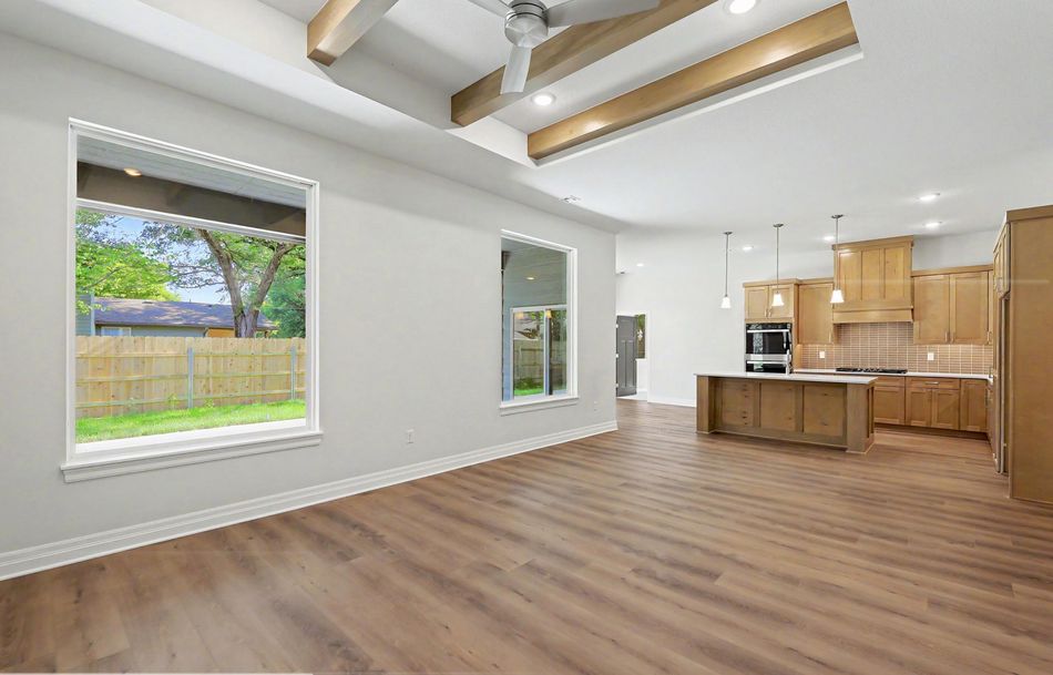 Open plan looking from the great room through to the kitchen at 116 S Byron Road by RJ Castle Homes, under beamed ceilings – Wichita, KS