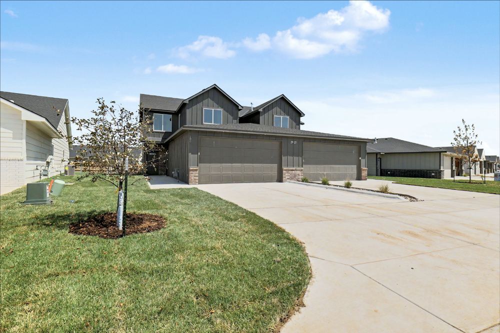 Angled view of the Cedar Crest duplex by RJ Castle Homes showing the full street elevation and finished driveway – Wichita, KS