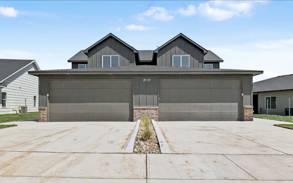 Cedar Crest duplex front elevation by RJ Castle Homes — two mirrored two-car garages, board-and-batten gables and brick bases – Wichita, KS