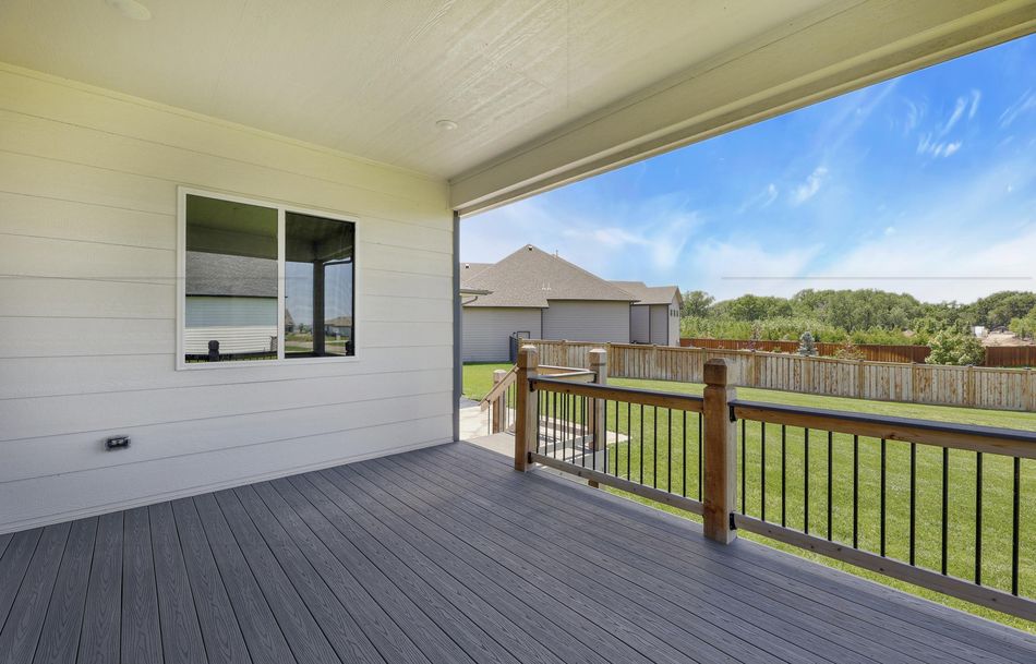 Covered composite deck at 2579 Doris Court with a planked ceiling and cedar-post rail overlooking the back lawn – Wichita, KS