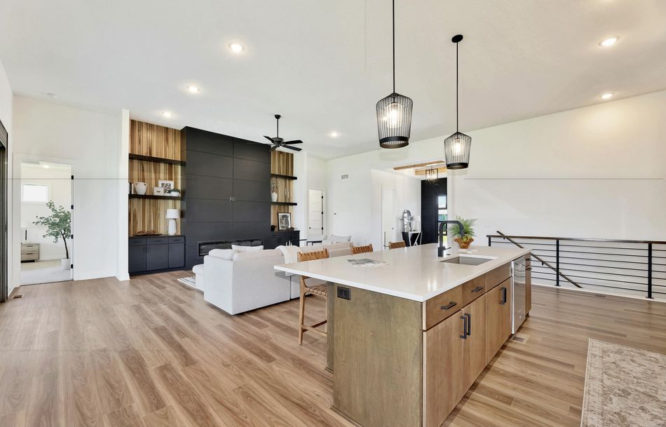 Kitchen island at 2579 Doris Court in light oak with a waterfall end, open across to the great room – Wichita, KS
