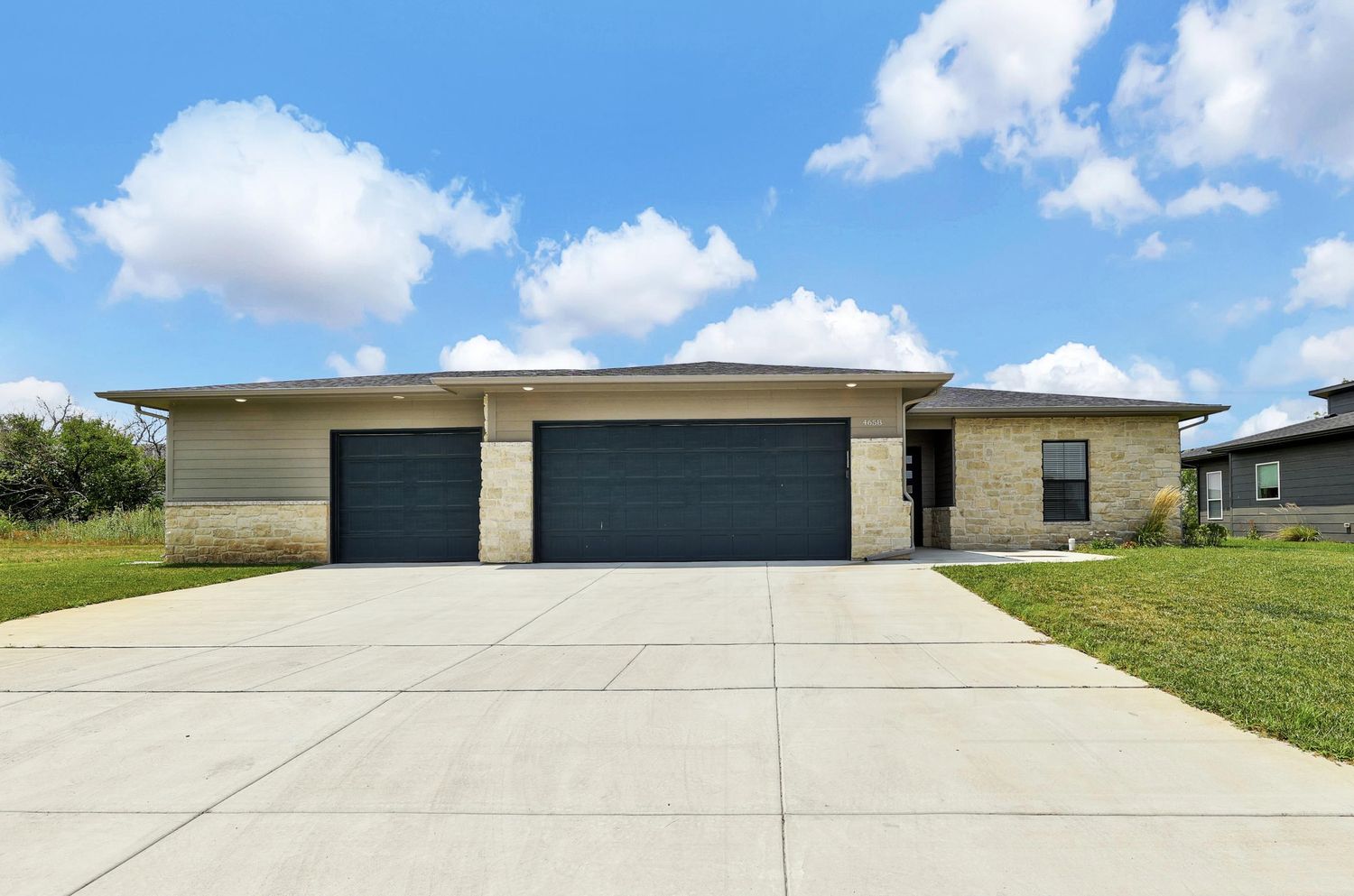 RJ Castle Homes stone-and-siding ranch at Emerald Bay Estates, one of its Wichita, KS home communities