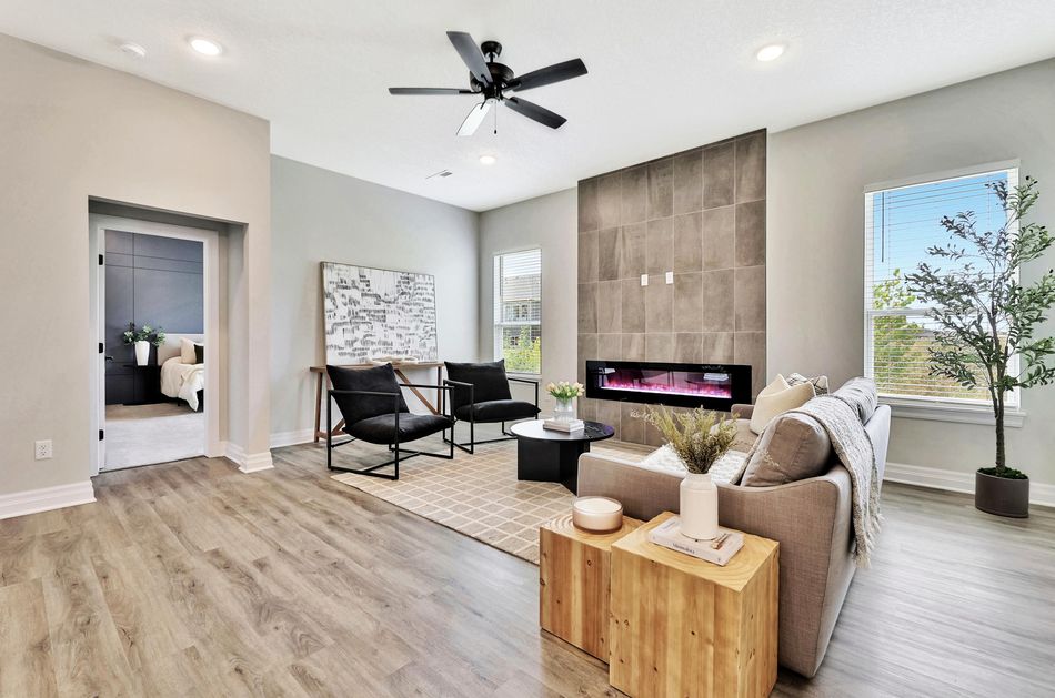 Great room at 4658 W Emerald Bay Court with a full-height tiled fireplace wall, a linear firebox and windows to both sides – Wichita, KS