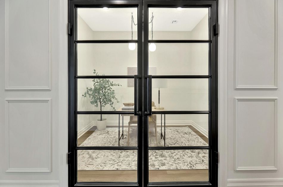 Black steel-framed glass double doors onto the study at 13650 W Homestead Drive, set into a panelled wall – Colwich, KS