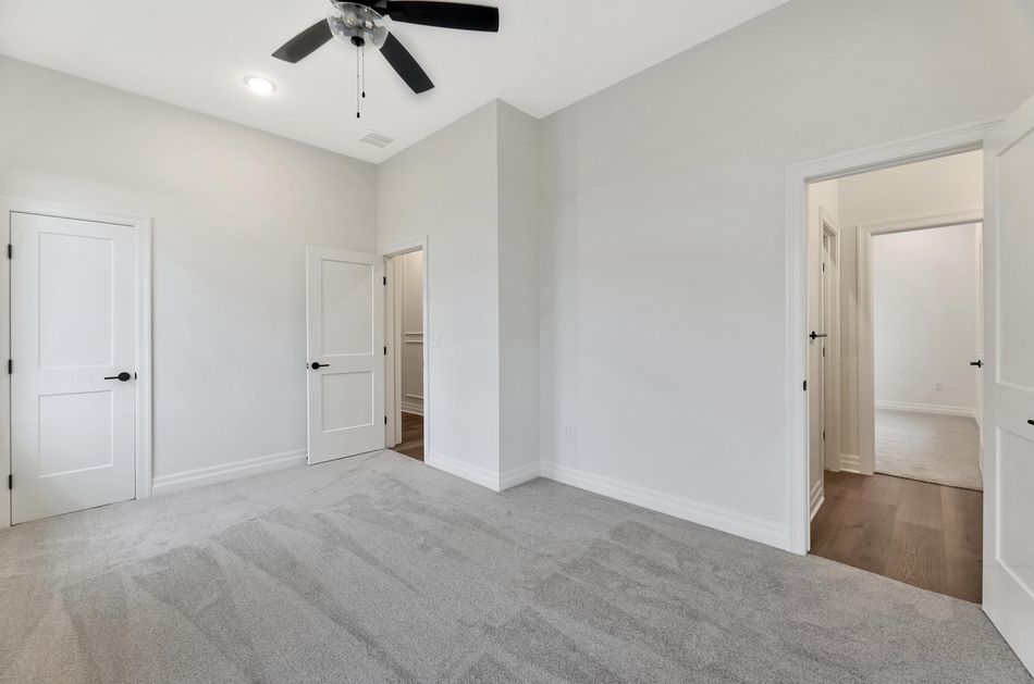 Primary bedroom at 13650 W Homestead Drive with carpet, a vaulted ceiling and doors through to the bath and closet – Colwich, KS