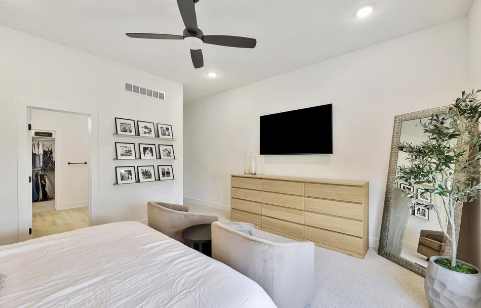 Primary bedroom at 5915 W Kollmeyer Court with a tray ceiling, carpet and a doorway through to the closet – Wichita, KS