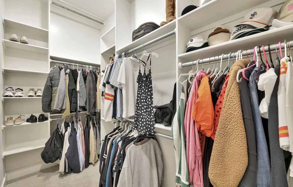 Fitted walk-in closet at 5915 W Kollmeyer Court with open shelving towers, double hanging rails and a shoe wall – Wichita, KS