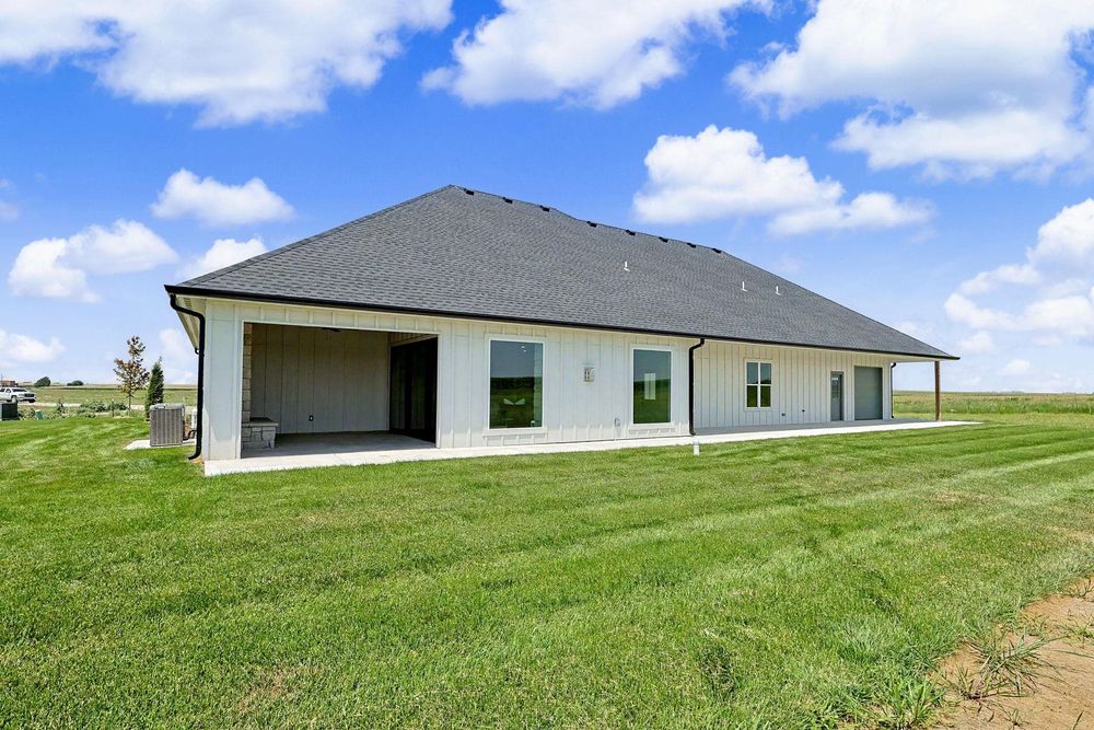 Rear exterior with the covered patio at 24465 W Stonebottom Ct near Goddard, KS