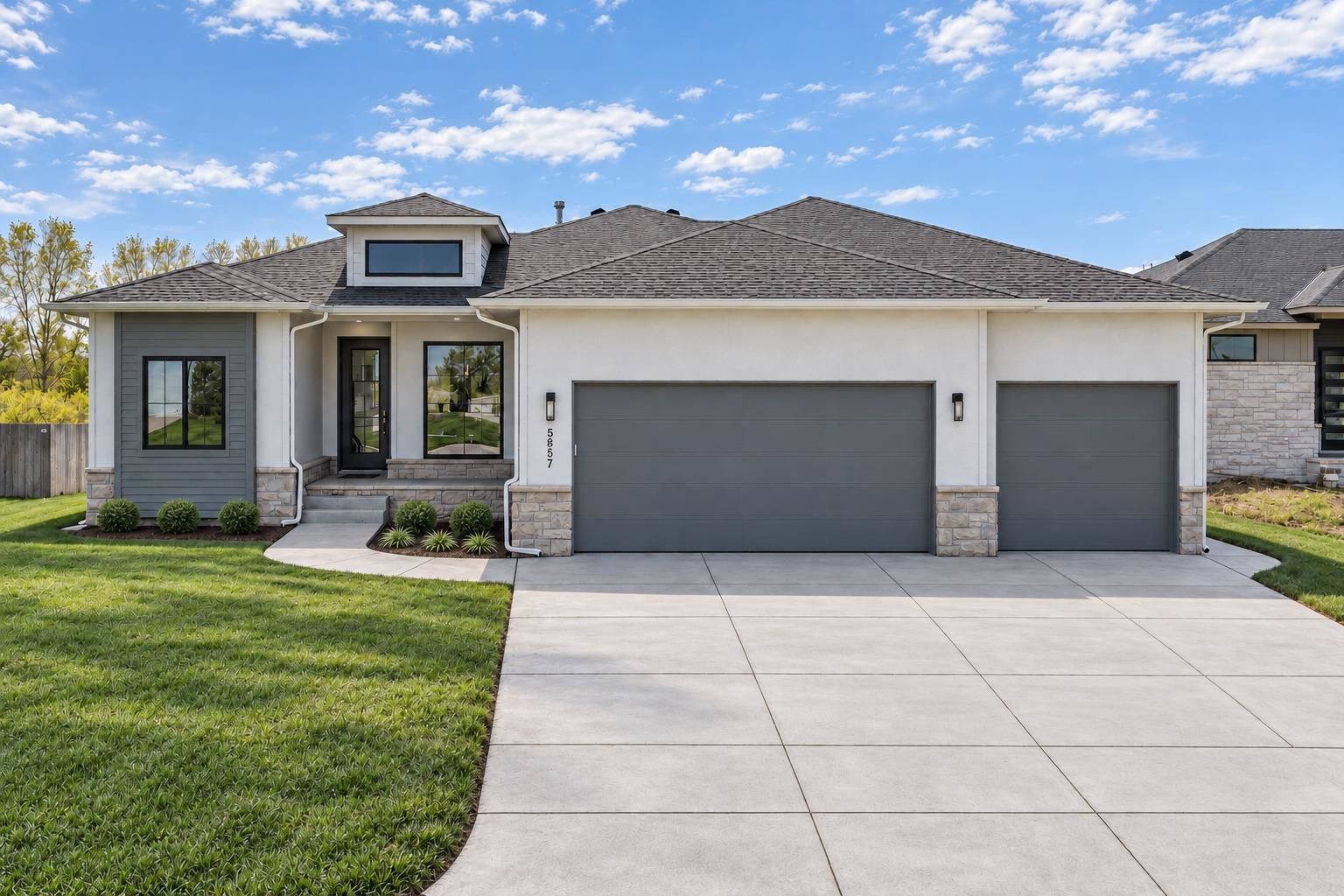 Front exterior of 5857 N St. Paul Ct, the Briarwood Plan with a 3-car garage, an RJ Castle home in Watermarke, Wichita, KS
