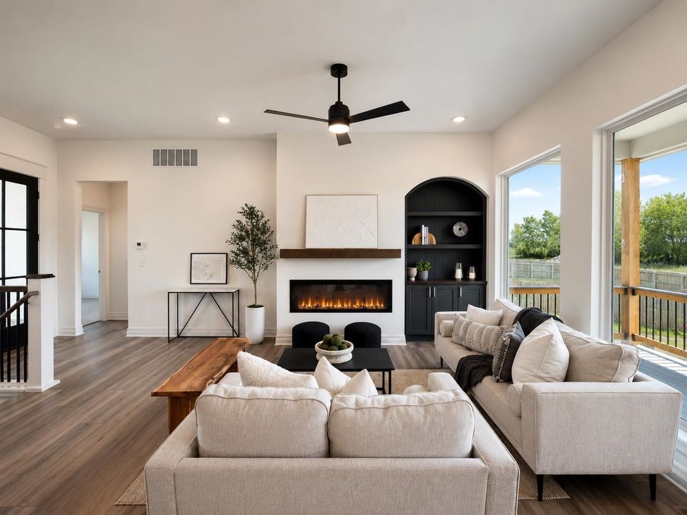Great room with a linear fireplace and arched built-ins at 5857 N St. Paul Ct, Wichita, KS