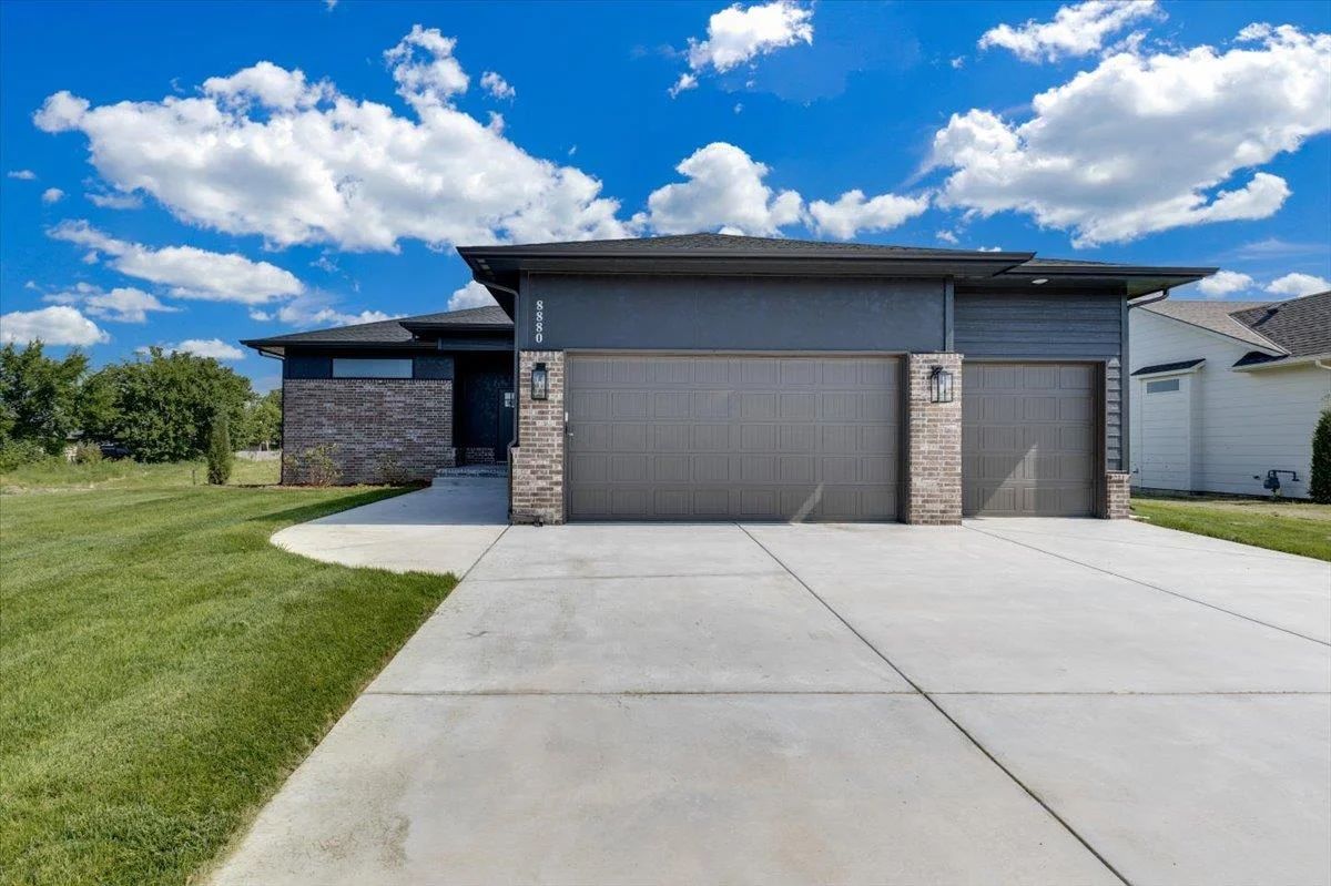 Front exterior of 8880 E Bradford St with a 3-car garage, an RJ Castle home in Rocky Ford, Derby, KS