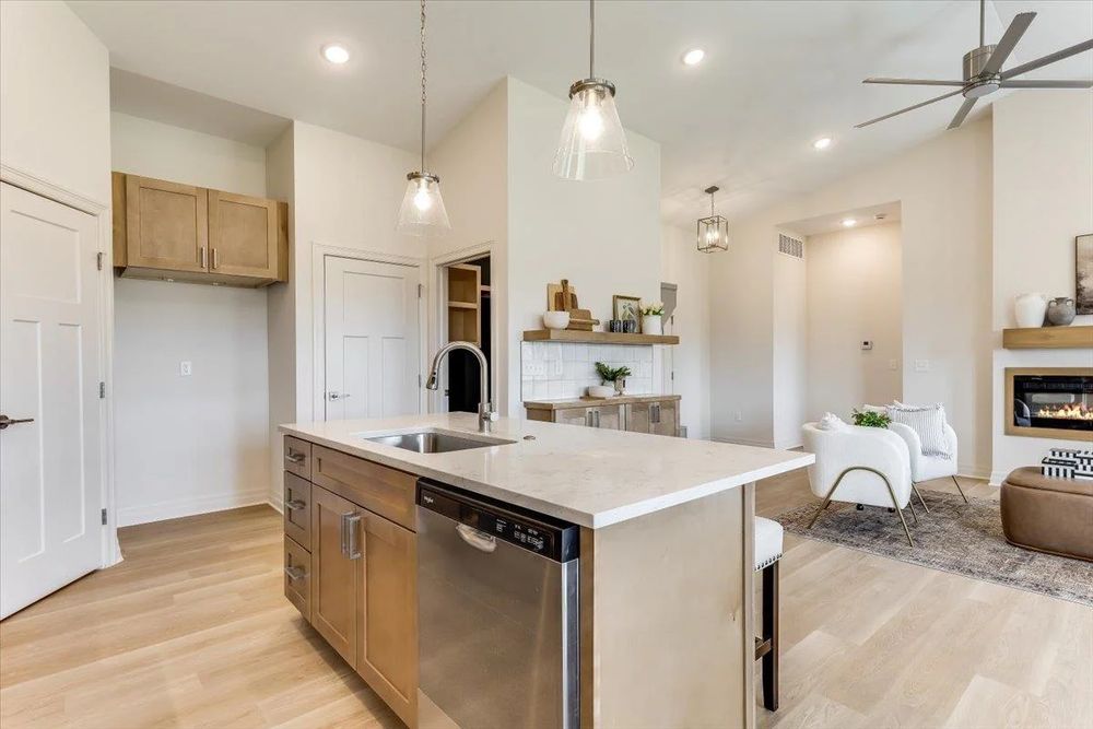 Open-concept kitchen with island and pendant lights at 8880 E Bradford St, Derby, KS
