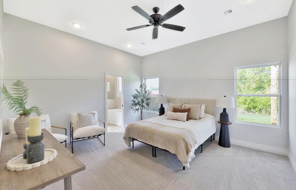 Primary bedroom at 517 S Sweetwater Road with carpet, a ceiling fan and windows on two walls – Maize, KS