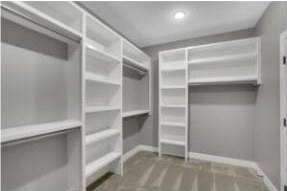 Completed RJ Castle Homes walk-in closet with custom built-in shelving – Wichita, KS